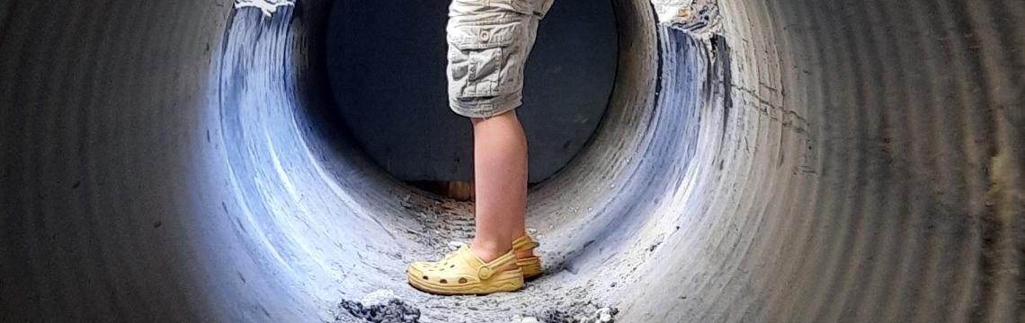 Image of child in tunnel wearing crocs